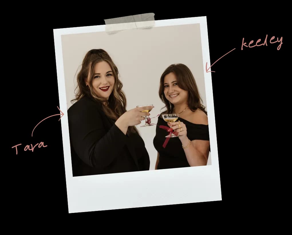 Polaroid photo of The Social Planner founders Tara and Keeley toasting with champagne coupes, with handwritten name labels