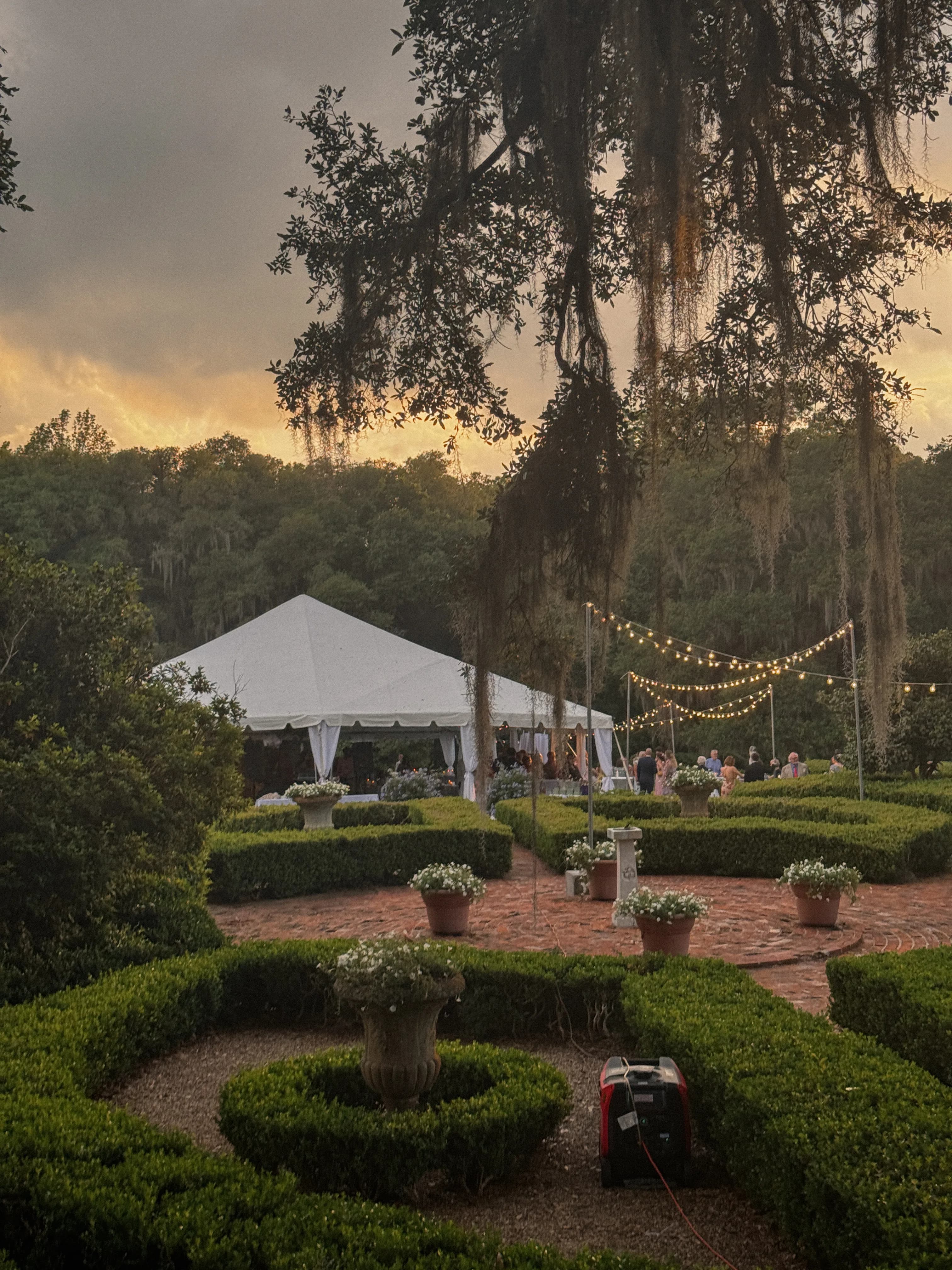 Outdoor wedding reception tent with string lights, venue stock photo